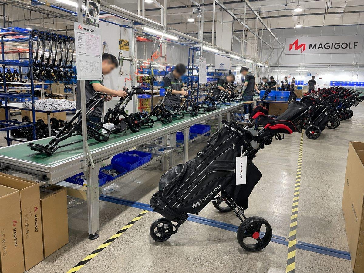 Golf push cart assembly line with workers fitting frames and wheels
