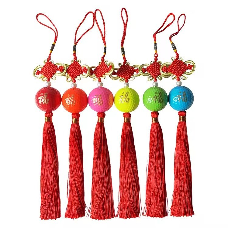 Golf-ball charms with red knot tassels in six colours