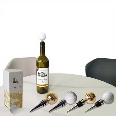 Golf-ball wine stoppers styled with a bottle on a table