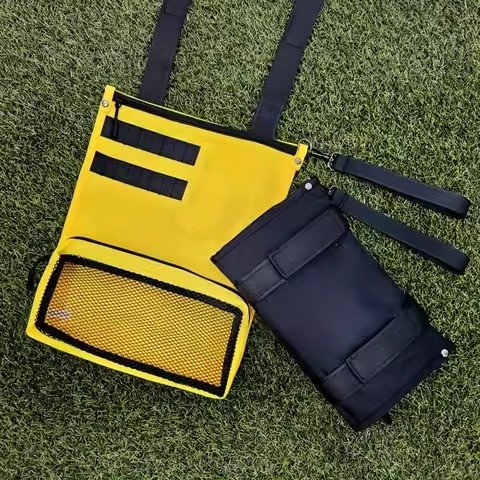 Yellow and navy accessory pouches on turf