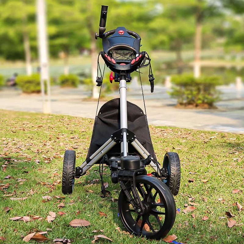 Front view of folding push cart with console and mesh basket on grass