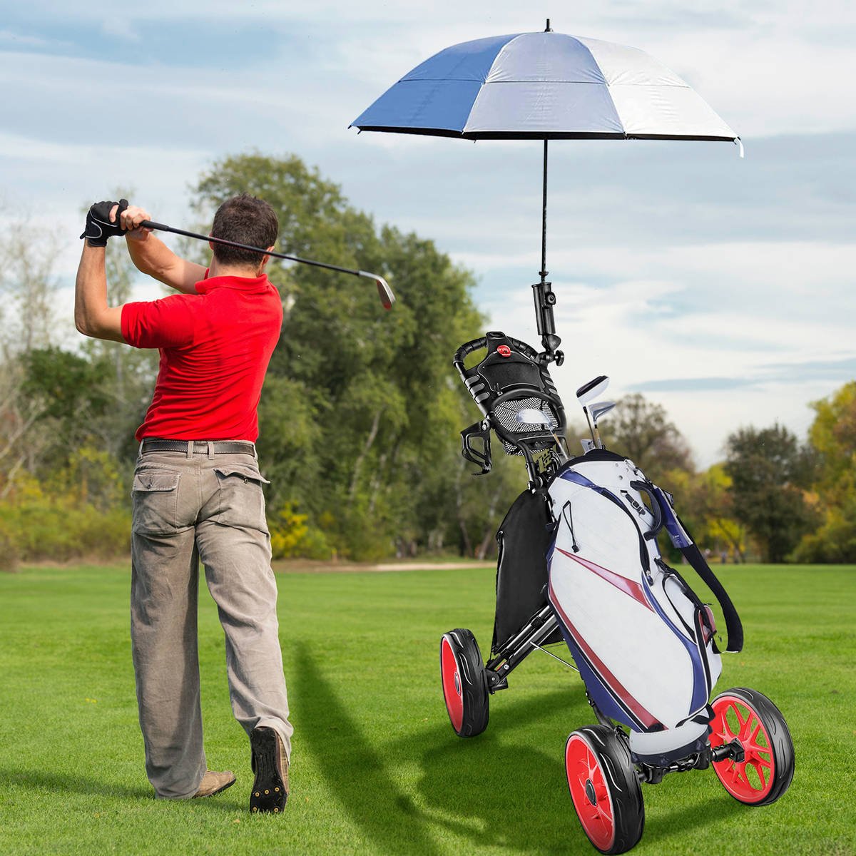 Golfer mid-swing beside the cart, white bag and umbrella mounted